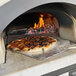 A pizza cooking in a Chicago Brick Oven wood-fired countertop oven.