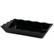 A black rectangular GET Milano melamine tray with wavy edges.