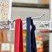 Red and blue cloths hanging from a Regency chrome ledge hook on a metal rack.