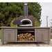 A Chicago Brick Oven wood-fired countertop pizza oven with a copper vein finish on a patio.