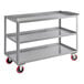 A grey metal Lavex utility cart with red wheels.