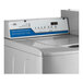 A white Encore commercial top load washer with blue and white buttons and dials.