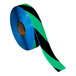 A roll of black and green tape with black stripes.
