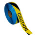 A roll of black and yellow striped "Caution" safety tape.