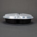 A black plastic container with three compartments and a clear plastic lid.