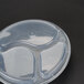 A black Pactiv plastic container with lid and three compartments.