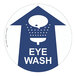 A blue and white Superior Mark "Eye Wash" safety floor sign with a speech bubble and arrow pointing up.