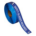 A roll of Superior Mark blue safety tape with white text reading "Safety Glasses Required" on it.