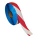 A roll of red and white striped Superior Mark safety tape.