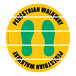A white rectangular floor sign with yellow and green text reading "Pedestrian Walkway" and yellow and green stripes.