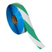 A roll of green and white striped Superior Mark safety tape.