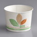 A white paper cup with green and brown leaves and the Bare by Solo logo.