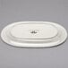 A white oval Tuxton China platter with an embossed rim.