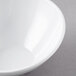 A close-up of a white San Michele slanted melamine bowl.
