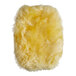 A yellow sheepskin mitt with fluffy fibers on a white background.