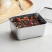 A Matfer Bourgeat stainless steel Japanese mini container with a lid and spoon.