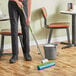 A person mopping a floor with a Lavex PVA mop.