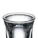 A close up of a clear Libbey tall shot glass.