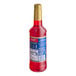 A red plastic Torani bottle of red liquid with a blue label.