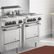 A Garland stainless steel electric restaurant range on a counter in a large commercial kitchen.