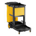 A black and yellow Lavex janitor cart with wheels and a yellow bag.