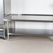 An Advance Tabco stainless steel equipment stand with undershelf.