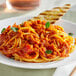 A plate of spaghetti with Red Gold Plant-Based Bolognese Style Pasta Sauce and toast.
