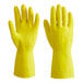 A close-up of a pair of yellow Lavex rubber gloves.