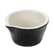 A black and white fluted ramekin with a spout.