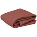 A stack of folded mauve Intedge rectangular table covers.