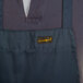 A close up of a Chef Revival navy blue apron with a pocket.
