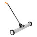 A long metal push sweeper with wheels and a handle.