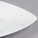 A close up of a CAC Super White porcelain square salad plate with a bowl shape.