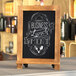 A Flash Furniture Canterbury tabletop chalkboard with a business lunch menu on it.