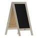 A Flash Furniture vintage white wood A-frame chalkboard with black board on display on a table.