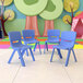 Three blue plastic Flash Furniture Whitney chairs in a colorful room.