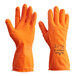 A close-up of a pair of orange Showa biodegradable nitrile gloves with an orange wrist.