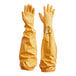 A yellow fabric bag with black writing that contains a pair of yellow Showa rubber gloves with rough grip and knit lining.