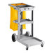 A Lavex gray janitor cart with a yellow bag on a shelf.