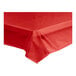A red Choice plastic table cover on a table.