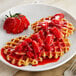 A plate of waffles topped with Oregon Fruit In Hand Strawberry Filling.