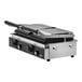 A Vollrath double cast iron panini grill with grooved plates on a counter.