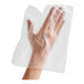 A hand in a clear plastic Pak-Sher glove.