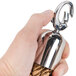A hand holding a metal hook attached to a braided bronze rope with chrome ends.