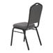 A National Public Seating black silhouette stack chair with a gray seat and black metal legs.