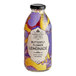 A close up of a Harney & Sons Organic Butterfly Flower Lemonade bottle with a colorful design.