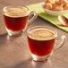 A glass cup of Lavazza Espresso Maestro Lungo coffee on a table.