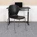 A black Flash Furniture Hercules stacking chair with metal legs.