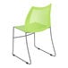 A green plastic Flash Furniture Hercules banquet chair with metal legs.