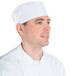 A man in a Chef Revival white mesh baker's hat and uniform.